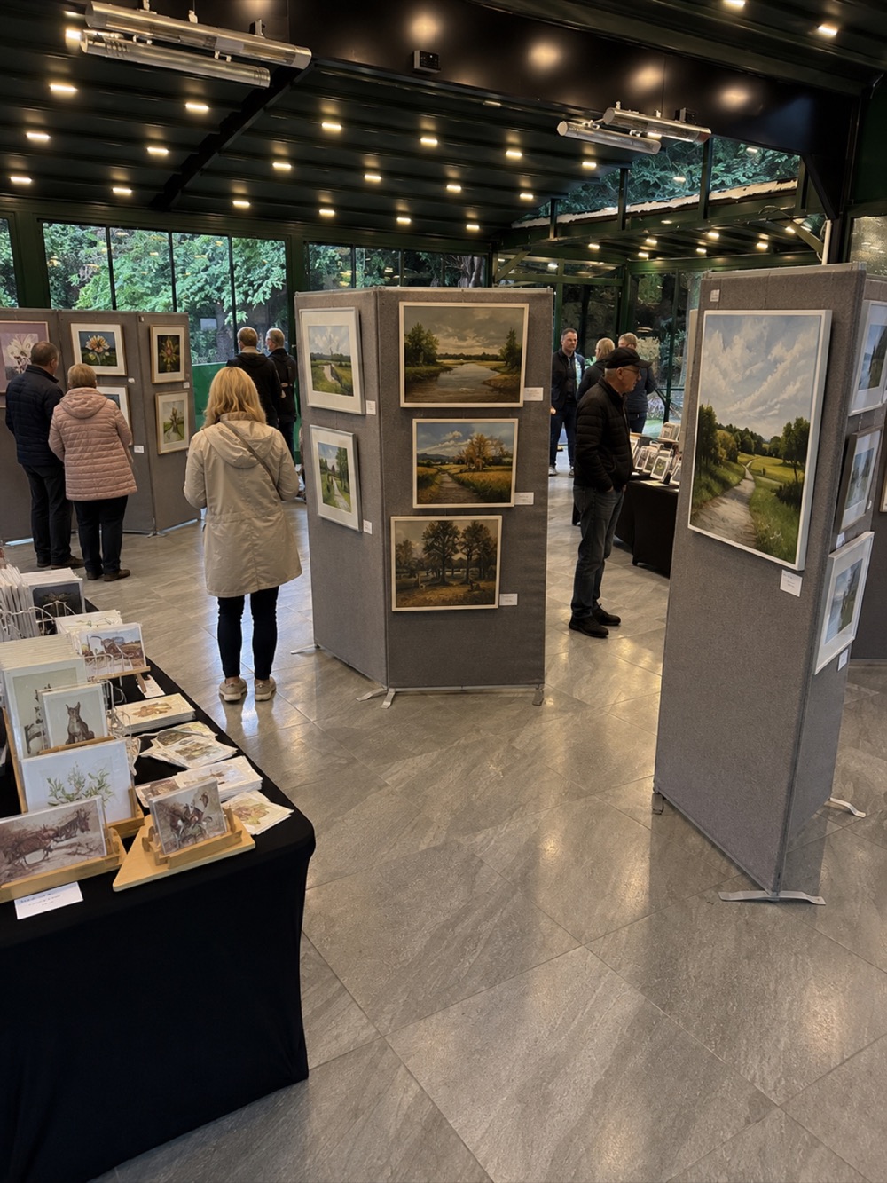 Visitors viewing landscape and botanical artwork at a CandWAG local art exhibition