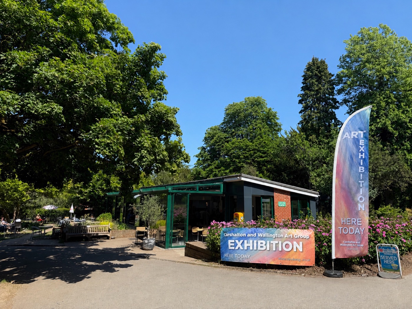 Oaks Park Café displaying Carshalton and Wallington Art Group exhibition signs